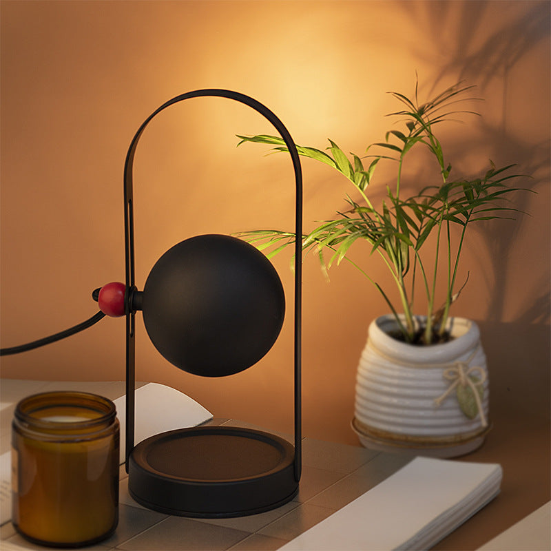 Aromatherapy wax lamp emitting a warm glow, designed to create a cozy and relaxing ambiance with soothing fragrances.
