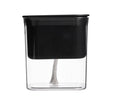 Transparent hydroponic planter with water reservoir, showcasing healthy green plants growing in a modern, clear gardening container.
