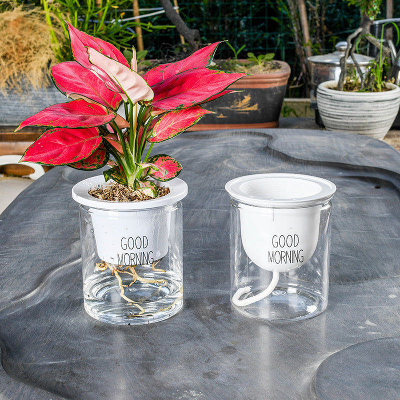 Double-tier self-watering planter with lush green plants, designed for easy indoor gardening and efficient water management.